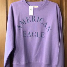 American Eagle Sweatshirt Size Medium Brand New With Tags Comes From A Smoke Free Home Casual Purple Sweatshirt With Letter Print, Purple Letter Print Sweater For Fall, Purple Letter Print Tops For Loungewear, Purple Letter Print Sweatshirt, Casual Purple T-shirt For Winter, Purple Letter Print Sweatshirt For Spring, Purple Letter Print Top For Fall, American Eagle Sweater Hoodie, Dark Green Hoodie