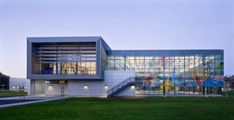 a large building with many windows on top of it's sides in the evening