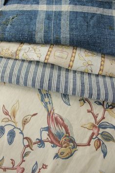 four pieces of blue and white fabric stacked on top of each other in different patterns