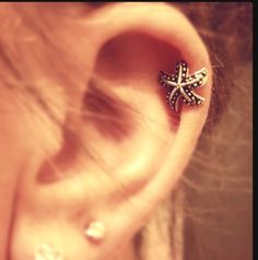 a woman's ear with a starfish design on it