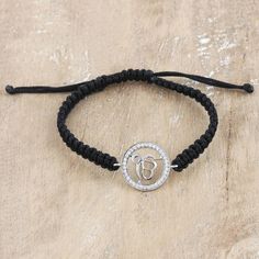 Designer Hema brings us a series of accessories aimed at the spiritual and courageous souls around the world. Collaborating with Indian artisans, Hema creates this black macrame bracelet featuring a comfortable cord and an adjustable sliding knot for an easy fit. The main element is a sterling silver round pendant embellished with cubic zirconia stones around a glorious Ek Onkar symbol, part of the Sikh philosophy, meaning "there is only one God." Spiritual Macrame Friendship Bracelets, Silver Macrame Spiritual Bracelets, Spiritual Bracelet With Adjustable Cord, Ek Onkar Symbol, Onkar Symbol, There Is Only One God, Ek Onkar, One God, Macrame Pendant