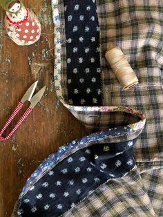 sewing supplies are laid out on a wooden table