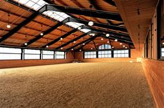 an empty horse barn with lots of windows