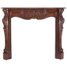 an ornate wooden fireplace mantel with carvings on the top and bottom, in dark wood