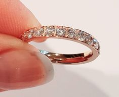 This is a gorgeous rose gold cubic zirconia band. 3 mm wide and super shiny. This band is 14 kt rose gold over stainless steel. Shines with a brillant fire. This ring is completely hypoallergenic, wear all day everyday. Swim, shower, very comfortable. Perfect to wear alone or as a spacer ring with any of my name rings. I guarantee customer satisfaction, and feel free to ask any questions. Rose Gold Stackable Rings With Prong Setting, Rose Gold Cubic Zirconia Stackable Rings, Fine Jewelry, Stackable Rose Gold Cubic Zirconia Diamond Ring, Classic Rose Gold Cubic Zirconia Stackable Rings, Rose Gold Cubic Zirconia Stackable Diamond Ring, Rose Gold Stackable Rings With Brilliant Cut, Rose Gold Eternity Band With Diamond Accents, Rose Gold Diamond Ring With Vs Clarity, Stackable Rose Gold Eternity Band For Promise