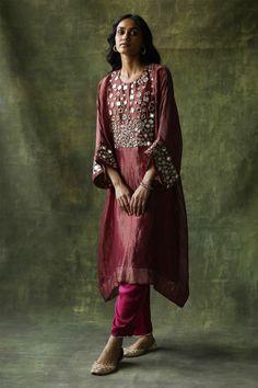 Ruby red zari silk kaftan kurta embellished with mirror work across the yoke and sleeves. Come with pants with mirror finished trims and a slip.
Component: 3
Pattern: Embroidery
Type Of Work: Mirror work
Neckline: Round
Sleeve Type: Loose sleeves
Fabric: Kurta: Zari Silk, Slip: Satin, Pant: Modal Satin
Color: Red
Other Details: 
Mirror work
Zari silk kurta
Occasion: Mehendi and Haldi - Aza Fashions Festive Silk Kaftan With Gota Work, Red Raw Silk Palazzo Set With Mirror Work, Red Silk Kurta With Mirror Work, Festive Silk Palazzo Set With Tunic Shape, Red Silk Palazzo Set With Mirror Work, Festive Silk Palazzo Set, Traditional Festive Kaftan With Sheer Dupatta, Festive Cotton Silk Kaftan, Festive Silk Tunic Sets