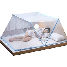 a woman laying on top of a bed under a glass dome