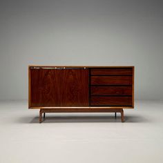 the sideboard has three drawers and two doors