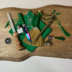 a wooden table topped with assorted items like a broom, wine glass and bottle opener