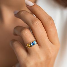 The Baguette Cut birthstone Ring features baguette cut stones prong set on a dainty gold band. A modern take on a gorgeous vintage design! M A T E R I A L * Solid: High-Quality Solid 925 Sterling Silver * Finish: Gold Vermeil∙ Rose Gold Vermeil * Cut: Oval-shaped brilliant cut * Gemstone: AAA quality Baguette Gemstone Gold Vermeil: The base metal is 925 Sterling Silver (perfect for sensitive skins). We add three layers of 14K gold/ rose gold or white gold, which gives your jewelry that extra, sp Dainty Gold Band, Baguette Cut Ring, Birthstone Ring Mothers, Ring Baguette, October Birthstone Rings, Birthstone Rings, Mom Ring, Mother Jewelry, Birthstone Colors