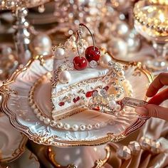 a piece of cake with cherries and pearls on it