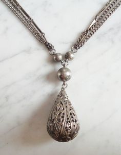 This listing is for a Vintage 3 Strand Silver tone Metal Necklace w Hollow Tear Drop Orb Pendant. This necklace measures 22 1/2 inches long. This is not marked or signed as far I I can tell. This necklace is in great shape with no damage or discoloration. A beautiful piece! See pics. Orb Necklace, Blue Glass Vase, La Crosse, Metal Necklace, I Can Tell, Necklace Vintage, Metal Necklaces, Tear Drop, Book Set