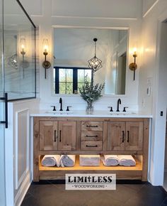 a bathroom with double sinks and wooden cabinets