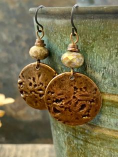 These are my handmade Copper Disc Earrings with earthy toned Czech glass beads. The copper metal discs are domed and have texture, with a very earthy tribal aesthetic, a bit Boho chic style. A great pair of everyday earrings! The ear-wires are hypoallergenic niobium wire, safer for sensitive ears. I create each piece of metal by hand, my jewelry is earthy, rustic, and organic with intentional artistic imperfections. No two pieces are exactly alike, creating truly one of a kind jewelry. ❤SIZE *7/ Earthy Bronze Dangle Jewelry, Adjustable Earthy Dangle Earrings, Bohemian Brown Beaded Nickel-free Earrings, Bohemian Bronze Earrings With Round Beads, Nickel-free Brown Beaded Earrings For Festival, Bronze Earthy Dangle Earrings, Rustic Nickel-free Round Bead Jewelry, Earthy Copper Jewelry For Festivals, Nickel-free Brown Bohemian Earrings