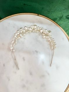 The Elle Pearl Bridal Headband is the perfect way to add a touch of on-trend elegance to any bridal gown, courthouse wedding dress, or engagement shoot. Covered in pearl accents of varying sizes, the double layered design elevates this hairpiece and imparts contemporary elegance. It can easily be added to any wedding hair style. The rounded metal edges allow it to be pinned into an updo if necessary. Available in Gold & Silver. Traditional Wedding Accessories, Courthouse Wedding Dress, Pearl Bridal Headband, Veil Hairstyles, Gold Headband, Courthouse Wedding, Nontraditional Wedding, Pearl Headband, Wedding Headband