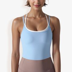 The Anna-Kaci Women's Double Strap Athletic Crop Tank Top with Built-In Bra is a stylish and practical addition to your activewear collection. This crop top features a sleek, double strap design that provides both support and a modern, sporty look. The built-in bra ensures added comfort and convenience, making it perfect for low to medium-impact workouts like yoga, Pilates, or strength training. Crafted from soft, stretchy fabric, this tank top offers a snug, flattering fit that moves with you d Blue Sleeveless Activewear With Built-in Bra, Sporty Tops With Built-in Bra For Sports, Sleeveless Sportswear Tops With Built-in Bra, Athleisure Tops With Built-in Bra For Training, Blue Crop Top With Built-in Bra For Gym, Athletic Fit Tops With Built-in Bra For Workout, Blue Tank Top With Built-in Bra For Yoga, Compressive Gym Top With Built-in Bra, Breathable Tops With Medium Support For Summer