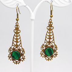 Long filigree earrings are a soft aged brass and have a green black glass stone at the bottom.   These are so pretty and lightweight.  The contrast of the brass and green is really nice.  The earwires were missing so I did replace them.  They are unmarked and in excellent condition.  The drops alone measure 1 3/4 inch and from the top of the earwire to the bottom of the drop they are 2 1/4 inch.  The kind of earring you find yourself reaching for all the time. Cute, dangly and comfortable.Find l Green Brass Earrings As Gift, Green Brass Earrings For Gift, Green Victorian Earrings As Gift, Ornate Green Earrings As Gift, Green Victorian Earrings For Gift, Elegant Green Copper Earrings, Victorian Green Earrings For Gift, Green Copper Pierced Earrings, Pierced Green Copper Earrings