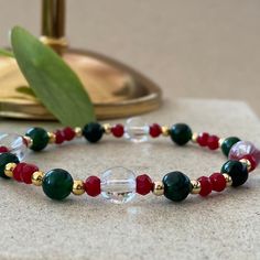 Christmas Bracelets This design bracelets are made of green agate, clear and red crystal beads.  When people think of the colors red and green, one thing comes to mind: Christmas.  Red has long been a powerful color associated with fire, spiritual awakening, and the blood of Jesus Christ, whose birthday is celebrated on December 25.  Green often symbolizes money, good luck, and health through the holidays and into the new year. ☆ Each of the pearls we use to create bracelets were formed by natur New Year Bracelet, Red Crystal Bracelet With Natural Stones For Gift, Red Natural Stones Crystal Bracelet Gift, Spiritual Red Jewelry For Christmas, Red Gemstone Beads Crystal Bracelet Gift, Red Beaded Crystal Healing Bracelet, Festive Christmas Bracelets With Round Beads, Festive Green Beaded Bracelets With Colorful Beads, Festive Green Beaded Bracelets