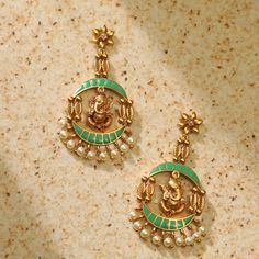 Description This traditional design yet trendy antique gold-plated earrings feature temple and modern elements: a beautiful lord Ganesh motif dangling in the center of the earring. Easy to style, this stylish earring suits any ethnic outfit at any time of the day. Details & Specifications: Materials used: Brass Alloy with Antique Plating Weight - Earrings 14 gm Length - Earrings 6 cm Make it custom Want to make it a custom earring? Sure! Reach out to us at support@tarinika.com and we’ll be happy Festival Brass Earrings With Cutdana, Brass Cutdana Temple Jewelry Earrings, Temple Jewelry Style Brass Cutdana Earrings, Temple Jewelry Style Brass Earrings With Cutdana, Festive Brass Chandbali Danglers, Temple Jewelry Cutdana Earrings For Navratri, Temple Jewelry Style Cutdana Earrings For Navratri, Brass Temple Jewelry Danglers For Diwali, Diwali Brass Temple Jewelry Danglers