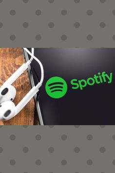 spotify earbuds sitting on top of a wooden table