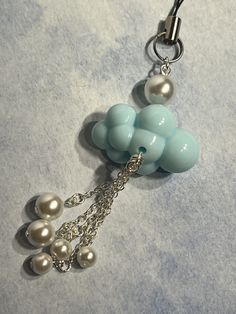 a key chain with pearls attached to it