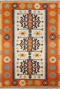 an orange and white rug with different colored designs on the front, side and back