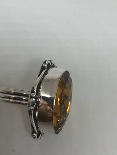 Large brilliant yellow antique glass Ornate German Silver NOT 925 Vintage ring, does not tarnish Size 7 My jeweler will re size for a $20 fee All rings are shipped free I. The US in a nice gift box. Check out our over a THOUSAND great reviews!!! Engraving is $4 per letter and is not always perfect depending on the piece. It can take a few days if the jeweler is busy. This is payable to Paypal Judithsltd@gmail.com Yellow Topaz Ring For Gift, Vintage Crystal Ring With Birthstone For Gift, Yellow Oval Crystal Ring Gift, Vintage Crystal Birthstone Ring As Gift, Vintage Birthstone Crystal Ring As Gift, Nickel Free Vintage Crystal Ring, Nickel-free Vintage Crystal Ring, Vintage Citrine Jewelry Gift, Vintage Adjustable Crystal Ring For Gift