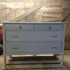 an old dresser is being painted in blue