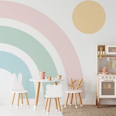 a child's play room with pastel colors and white furniture