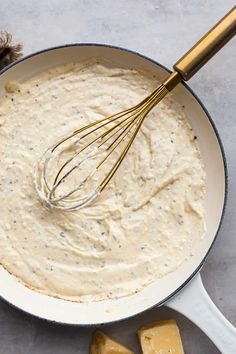 a pan filled with batter and cheese on top of a table