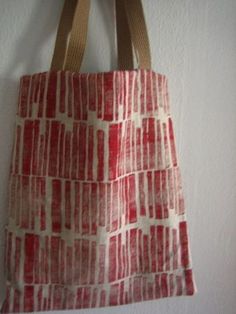 a red and white bag hanging on a wall