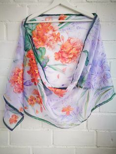 Hand painted Recherché silk scarf -Violet Brodiaea (Cluster lilies) flowers and coral geraniums in soft purple lavender air. Scarf painted on Ponge silk (sometimes called habotai). It is light, soft, just a little glossy and slightly sheer silk. ------------------------------------------------------------------------------------------------------------------ This scarf is MADE TO ORDER and available even in 6 OBLONG sizes and 3 SQUARES: 21x21 inches (55x55cm)- Very small square- Kerchief; wrist, Purple Silk Scarf With Floral Print For Spring, Purple Bohemian Scarves With Floral Print, Purple Floral Print Silk Scarf For Spring, Purple Silk Scarves With Floral Print, Purple Silk Scarves For Spring, Purple Silk Shawl Scarf, Summer Purple Silk Scarf As A Gift, Purple Silk Scarf For Summer Gift, Summer Gift Purple Silk Scarf