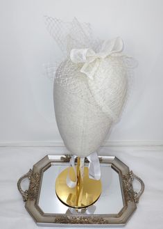 100% Sinamay straw ivory off-white  teardrop fascinator percher hat, vintage inspired with French veiling and sinamay bow. Length of 6 inches (15.25 cm), Width of 4.75 inches (12 cm). Cute, dainty and feminine hair accessory. Hair comb attached. Wear this ivory off-white  fascinator hat for any special occasions, weddings, bridal showers, tea parties, Church, Kentucky Derby, Royal Ascot, Queen's Plate, any race day or fashion event. Teardrop Fascinator, Feminine Hair, Race Day Fashion, White Fascinator, Sinamay Fascinator, Bridal Shower Tea, Fascinator Hat, Royal Ascot, Day Fashion