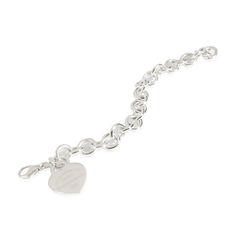 Tiffany & Co. Return To Tiffany Heart Tag Bracelet in  Sterling Silver  PRIMARY DETAILS  SKU: 141364  Listing Title: Tiffany & Co. Return To Tiffany Heart Tag Bracelet in  Sterling Silver  Condition Description: Tiffany reinvents a classic with the Return To Tiffany collection. Originally designed in 1969, the Tiffany keyring is the source of inspiration behind this line-up, which is defined by its engraved heart-shaped pendant.     Retails for 575 USD. In excellent condition and recently polished. 7 inches in length. Comes with Pouch;  Brand: Tiffany & Co.  Collection/Series: Return To Tiffany  Metal Type: Sterling Silver  Metal Purity: 925  Chain or Bracelet Length (in): 7  Pre-Owned Jewelry Condition: Excellent  SIDE STONE INFORMATION  Original Box?: No  Original Papers?: No  This item Chanel Charm Bracelet, Contemporary Bracelets, Tiffany And Co Jewelry, Return To Tiffany, Vintage Charm Bracelet, Heart Tag, Gold Charm Bracelet, Tiffany Co Jewelry, Diamond Charm