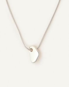 Inspired by the forms of Barbara Hepworth. Its organic shape gives the appearance of a pierced stone. This everyday necklace is made to live with you night and day. First molded by hand in wax, then casted in silver and lastly ultra high polished for a mirror effect. Minimalist Hand Cast Sterling Silver Necklace, Silver Minimalist Jewelry With Large Stone, Minimalist Silver Jewelry With Large Stone, Modern Sterling Silver Jewelry With Large Stone, Hernan Herdez, Cape Cod Bracelet, Barbara Hepworth, Night And Day, Mirror Effect