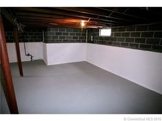 an empty room with white walls and black bricks on the wall is shown in this image