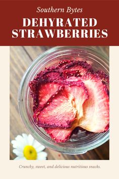 a jar filled with sliced strawberries on top of a wooden table