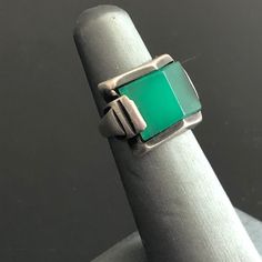 "What a great Art Deco ring! The chrysoprase stone is stunning in shape and translucence. Chrysoprase has been a choice stone in some of the best jewelry styles, from Art Nouveau (Georg Jensen featured it often) to Scandinavian Modern (it was a favorite of mid-century artists from Denmark, Finland, Norway, and Sweden.) In the Art Deco era, chrysoprase enhanced pieces from affordable marcasite silver jewelry to luxurious diamond-studded platinum pieces by makers like Cartier. This chrysoprase has Luxury Gift Chrysoprase Emerald Ring, Luxury Formal Chrysoprase Rings, Antique Turquoise Gemstone Ring For Formal Occasions, Classic Green Opal Cabochon Ring, Vintage Emerald Rings With Polished Finish, Classic Chrysoprase Gemstone Jewelry, Green Sterling Silver Art Deco Jewelry, Antique Green Jewelry With Polished Finish, Classic Green Opal Ring For Formal Occasions