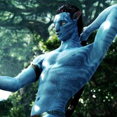 a man dressed as avatar from avatar is holding a tennis racket in his hand