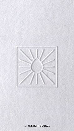 the front cover of a white book with an image of a sun in the center