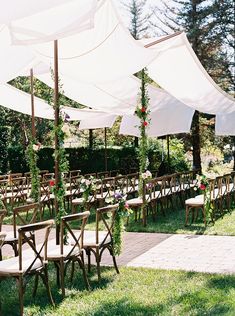 rows of chairs and umbrellas set up for an outdoor ceremony