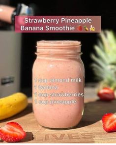 a strawberry pineapple banana smoothie in a mason jar