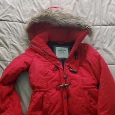 Abercrombie Red Jacket With Zipper And Wood Buttons. Never Worn. Had Removable Fur On The Hood Red Outerwear With Detachable Hood For Fall, Red Winter Outerwear With Detachable Hood, Red Long Sleeve Outerwear With Detachable Hood, Red Winter Parka With Pockets, Red Parka With Pockets For Fall, Red Padded Collar Outerwear For Cold Weather, Red Outerwear With Padded Collar For Cold Weather, Red Long Sleeve Outerwear With Padded Collar, Fitted Red Outerwear For Cold Weather