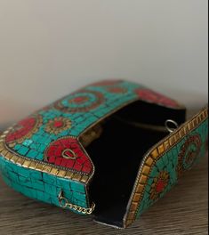 This statement green clutch is a true work of art, crafted with meticulous attention to detail. It showcases a mesmerizing design composed of vibrant, colorful mosaic patterns that catch the eye and add a touch of elegance to any outfit. At Indus Threads, we believe that accessories should not only be functional but also make a bold fashion statement. That's why our Mosaic Purse stands out from the crowd with its distinct and captivating aesthetic. It is designed to be a versatile accessory, per Turquoise Rectangular Evening Shoulder Bag, Turquoise Rectangular Shoulder Bag For Evening, Multicolor Bohemian Bags For Formal Occasions, Handmade Green Rectangular Evening Bag, Traditional Multicolor Shoulder Bag For Formal Occasions, Traditional Multicolor Clutch For Formal Occasions, Traditional Multicolor Formal Shoulder Bag, Multicolor Rectangular Evening Bag, Handmade Multicolor Evening Bag For Formal Occasions