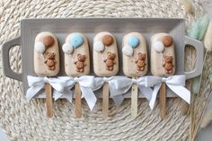 there are five desserts on sticks in the shape of teddy bears and bear cubs