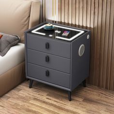 a night stand with two drawers on each side and a remote control in the middle