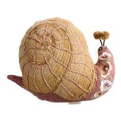 a snail is sitting on top of a ball of yarn and has its head turned to the side