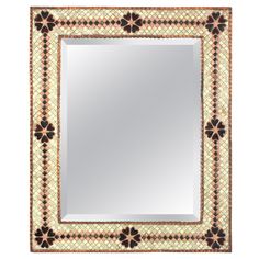 a square mirror with an ornate border around it