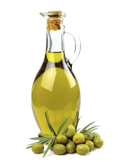 an olive oil bottle and some green olives