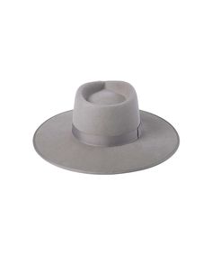 Inspired by vintage men’s styles, this hat is designed to make a statement. A stiffened wool fedora with rigid crown design. Trimmed on hat and rim with tonal gross grain ribbon. STONE GREY Rancher fedora hat Trimmed with tonal grey gross grain edged hat rim and bow ribbon detail 100% soft Australian wool Spot / specialist clean Brim measures 10 cm / 3.95” Classic crown height Rigid crown design Unisex style This hat is accredited with a UPF Rating 50+ (Australian Tested) Size + Fit: Rancher siz Wool Fedora, Bow Ribbon, Halo Style, Stone Grey, Crown Design, Wearing A Hat, Grey Stone, Fedora Hat, Unisex Style